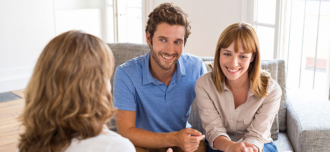 Mortgage Broker Explaining a Couple Interested in Buying a House